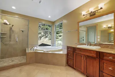 a bathroom with two sinks and a shower and a tub at Heavenly Mountain Chalet - Skiing Pets Hot tub in Stateline