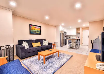 a living room with a couch and a table at Lakeland Getaway - Walk to Lake in South Lake Tahoe
