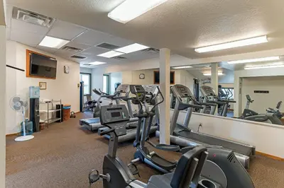 a gym with treadmills and elliptical machines at Lakeland Getaway - Walk to Lake in South Lake Tahoe