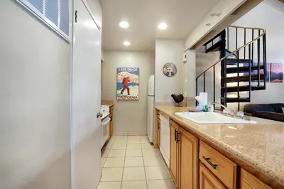 a kitchen with a sink and a refrigerator at Lakeland Sandy Beach Retreat - Private Escape in South Lake Tahoe