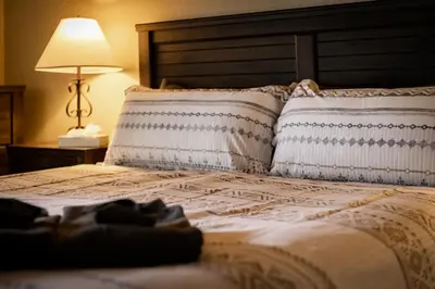 a bedroom with a bed with two pillows and a lamp at Lakeland Sandy Beach Retreat - Private Escape in South Lake Tahoe