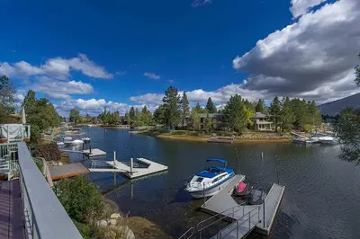 a group of boats are docked in a river at Lucerne Lake House - Ski Lease 30plus Days in South Lake Tahoe