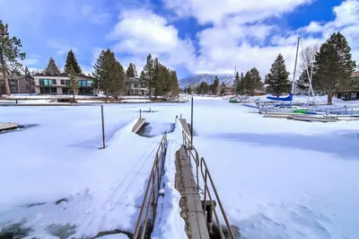 a snow covered parking lot with a fence on it at Lucerne Lake House - Ski Lease 30plus Days in South Lake Tahoe