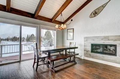 a dining room with a table and a fireplace at Lucerne Lake House - Ski Lease 30plus Days in South Lake Tahoe