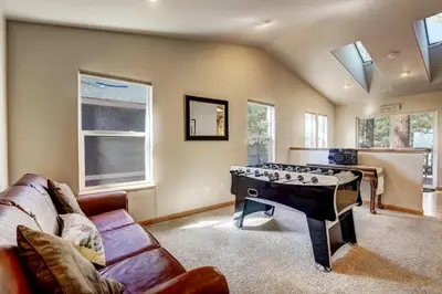 a living room with a ping pong table at Montgomery Estates Bliss - Hot tub pets family fun in South Lake Tahoe