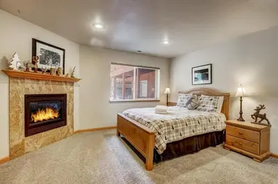 a bedroom with a bed and a fireplace at Montgomery Estates Bliss - Hot tub pets family fun in South Lake Tahoe