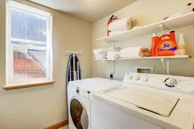 a laundry room with a washing machine and a window at Montgomery Estates Bliss - Hot tub pets family fun in South Lake Tahoe