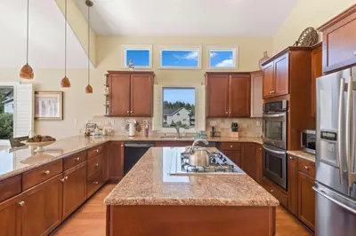 a large kitchen with wooden cabinets and a counter top at Mule Meadows - Classy Split level South Tahoe home in South Lake Tahoe