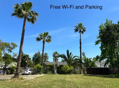 a house with palm trees in a yard at Private Suites in Sacramento