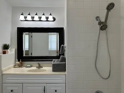 a bathroom with a shower and a sink at Private Suites in Sacramento