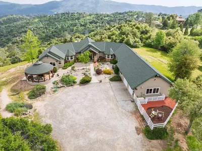 an aerial view of a home with a large yard at Yosemite Cloudline Ridge in Oakhurst