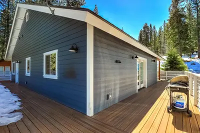 a house with a blue building with a deck at Amachen Cabin - Pet & Family Friendly - woof woof in South Lake Tahoe