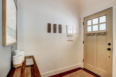 a hallway with a wooden table and a door at Amachen Cabin - Pet & Family Friendly - woof woof in South Lake Tahoe