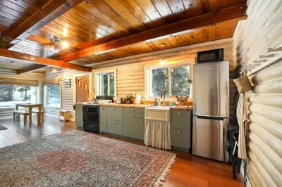 a kitchen with a refrigerator and a sink in it at Augies Authentic Log Cabin Pets Welcome in South Lake Tahoe