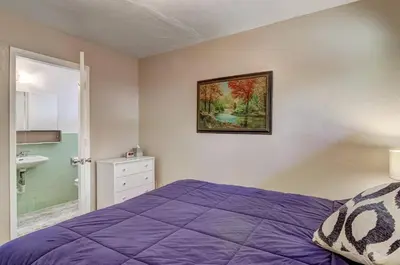 a bedroom with a purple bed and a bathroom at Blue Black Bart - Foosball Near Town & More in South Lake Tahoe