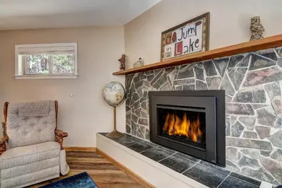 a living room with a fireplace and a chair at Blue Black Bart - Foosball Near Town & More in South Lake Tahoe