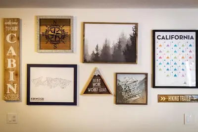a wall with framed pictures on a wall at The Blue Lake House - Family fun Abound in South Lake Tahoe