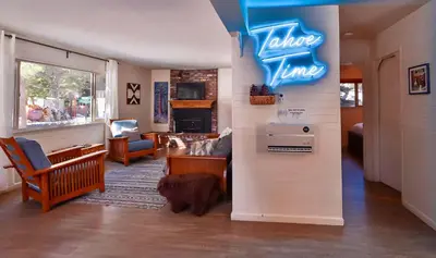 a living room with a sign that reads slow time at Charming Cherokee Cabin - Secluded Stay for 6 Just 10 Minutes to Tahoe in South Lake Tahoe