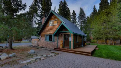 a small house with a porch and a deck at Charming Cherokee Cabin - Secluded Stay for 6 Just 10 Minutes to Tahoe in South Lake Tahoe
