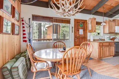 a kitchen and dining room with a table and chairs at Cherry Hills Cabin - Sleeps 6 No Pets Family Fun in South Lake Tahoe