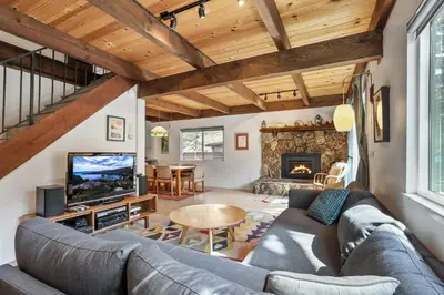 a living room with a couch and a tv at Christmas Valley Chalet - Tahoe Adventure Awaits in South Lake Tahoe