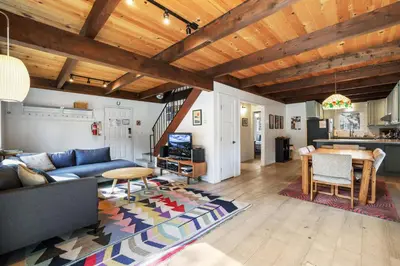 a living room with a blue couch and a table at Christmas Valley Chalet - Tahoe Adventure Awaits in South Lake Tahoe
