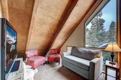 a living room with a couch and chairs and a large window at Cold Creek Chalet - Hot tub & Movie Room in South Lake Tahoe