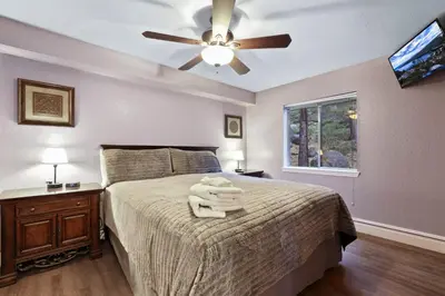 a bedroom with a bed with a ceiling fan at Ski In Ski Out 3 BDR Steps from Stagecoach Lift in Stateline