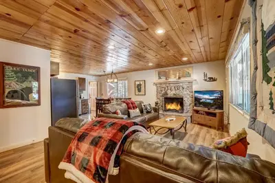 a living room with a couch and a fireplace at Come Snuggle Up at Cozy Bear Cabin in South Lake Tahoe