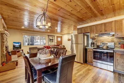 a kitchen and dining room with a table and chairs at Come Snuggle Up at Cozy Bear Cabin in South Lake Tahoe