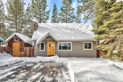 a house with a snow covered roof at Dancing Bear Cabin - Pet Friendly Sleeps 4 Totally cute in South Lake Tahoe