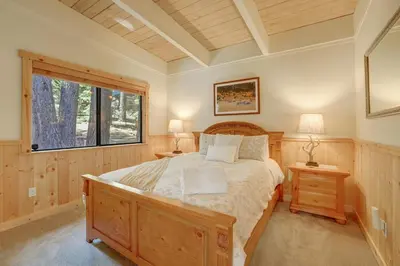 a bedroom with a large bed and a window at Shady Pines Pets Hot tub in South Lake Tahoe