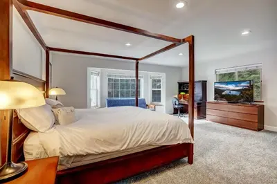 a bedroom with a large canopy bed and a desk at Nestled Pines Retreat Hot Tub Pool Tahoe Foosball More in South Lake Tahoe