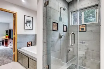 a bathroom with a shower and a toilet and a sink at Nestled Pines Retreat Hot Tub Pool Tahoe Foosball More in South Lake Tahoe