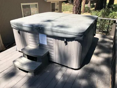 a hot tub sitting on top of a wooden deck at Prima Del Norte - Hot tub Pool Table Arcade Game in South Lake Tahoe