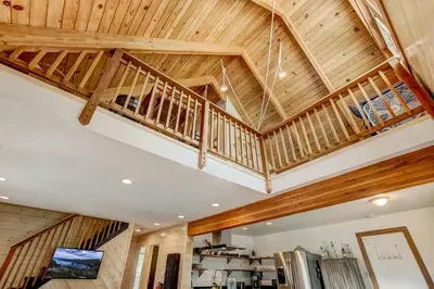 a large room with wooden ceilings and wooden rafters at Rustic Haven - Hot tub & Pet friendly in South Lake Tahoe