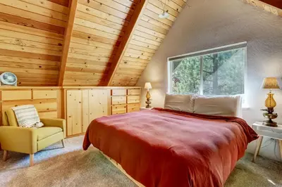 a bedroom with a large bed and a window at Rustic Haven - Hot tub & Pet friendly in South Lake Tahoe