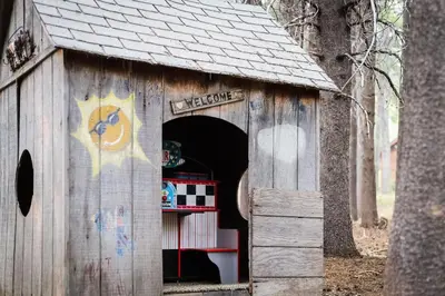 a wooden dog house with a door open at Serenity Woods - Game Room & More in South Lake Tahoe