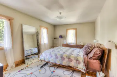 a bedroom with a bed and a chair and a mirror at Shining Shire - Sauna steam shower very cool in South Lake Tahoe