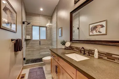 a bathroom with a sink and a shower with a mirror at It's a Sierra State of Mind - Family Fun in South Lake Tahoe