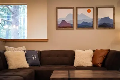a brown couch in a living room with three pictures at It's a Sierra State of Mind - Family Fun in South Lake Tahoe