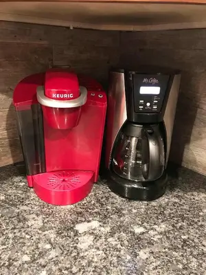 a red coffee maker and a coffee pot on a counter at Silver Pines - Ski or Summer 30 plus day home in South Lake Tahoe