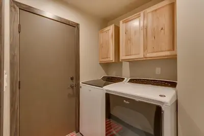a small kitchen with a washer and dryer at Silver Pines - Ski or Summer 30 plus day home in South Lake Tahoe