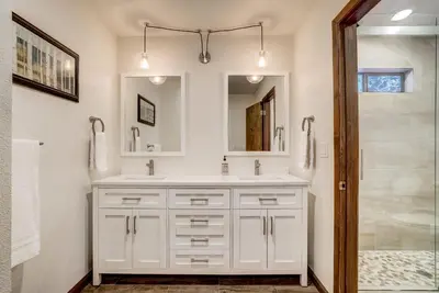 a white bathroom with a sink and a shower at Singing Pines in Marla Bay - Walk to Lake in Glenbrook