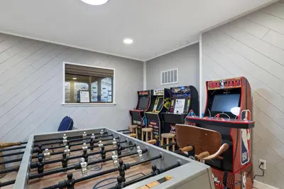 a room with a bunch of pinball machines at Southern Pines Arcade Games & Foosball for Kids in South Lake Tahoe