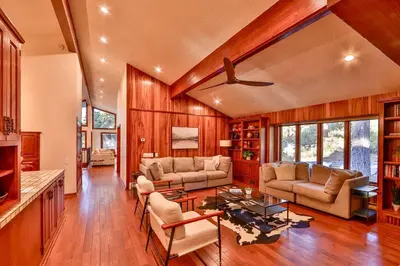 a living room with a couch and a table at Sunset Cove Chic Tahoe Retreat in Glenbrook