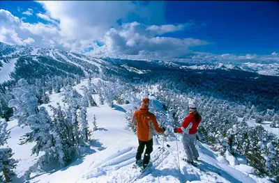 two people standing on top of a snow covered mountain at Sutter Trail Sparkles - Air conditioned large family home in South Lake Tahoe