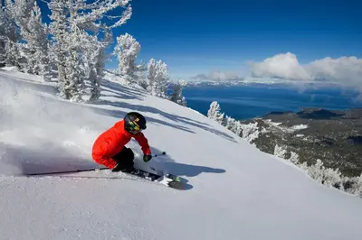 a person riding a snowboard down a snow covered slope at Tahoe Family Getaway in Stateline