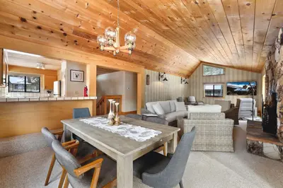a dining room and living room with a table and chairs at Tahoe Forest Chalet 3BR House with AC in Stateline