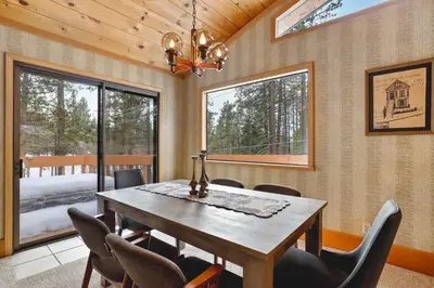 a dining room with a wooden table and chairs at Tahoe Forest Chalet 3BR House with AC in Stateline